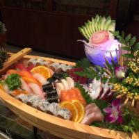 Sushi and Sashimi Boat for 2 · 15 pieces of sashimi, 10 pieces of sushi and 3 rolls: dragon roll, rainbow roll and Christma...