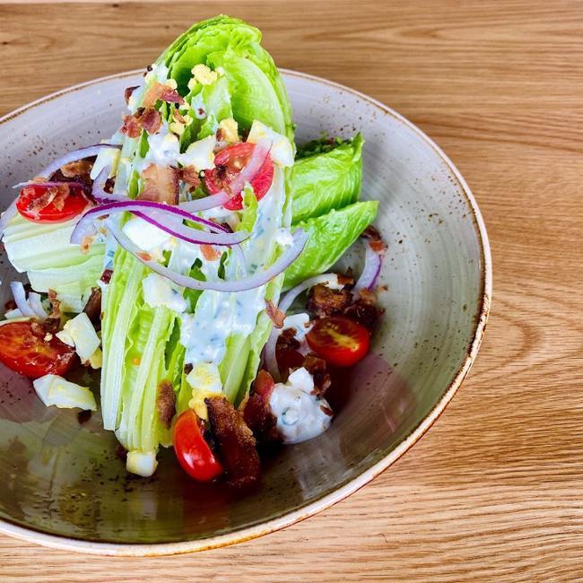 101 Wedge Salad · Baby Romaine, Double Smoked Bacon, Cherry Tomatoes, Hard Boiled Egg, Red Onion & House Blue Cheese Dressing