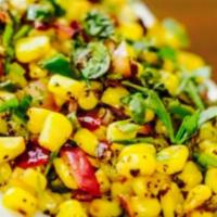 Spicy Corn · Sauteed corn with fresh tomatoes, onion, and peanut spicy dressing.
