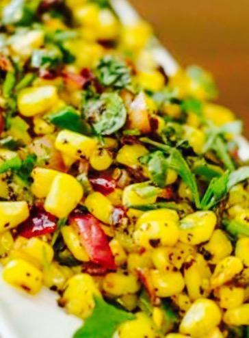 Spicy Corn · Sauteed corn with fresh tomatoes, onion, and peanut spicy dressing.