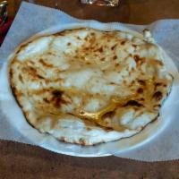 Naan · Special semi-leavened dough mixed with milk, butter and freshly baked in a clay oven. Butter...
