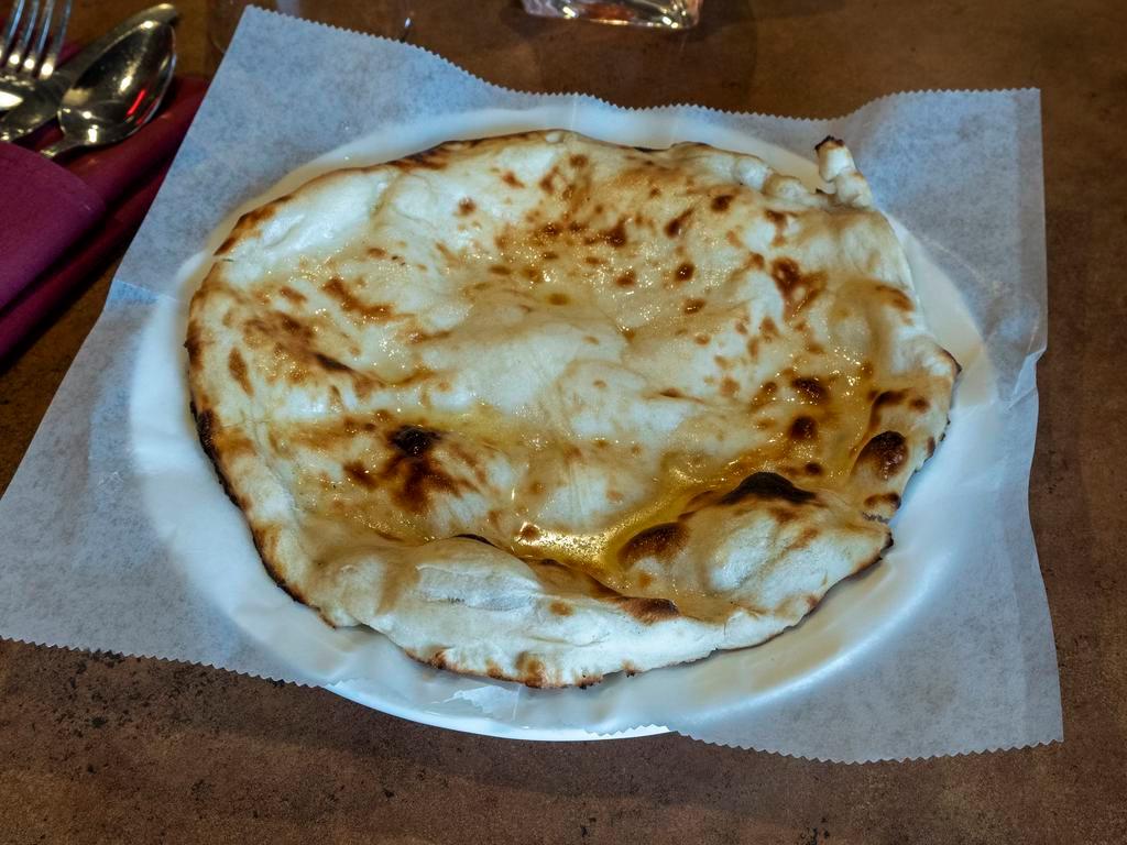 Naan · Special semi-leavened dough mixed with milk, butter and freshly baked in a clay oven. Buttery Good