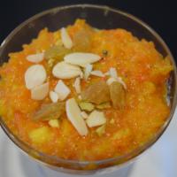 Gajar Halwa · Freshly grated carrots cooked in traditional Indian style served warm.