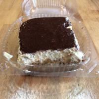 Tiramisu Glass · Sponge cake soaked in espresso topped with mascarpone cream and dusted with cocoa powder.