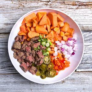 Boss Bowl · 2 organic grass-fed bison patties, grilled sweet potatoes, red onions, green onions, red peppers and jalapenos.
