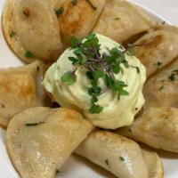 Potato Perogies · sour cream and caramelized onions