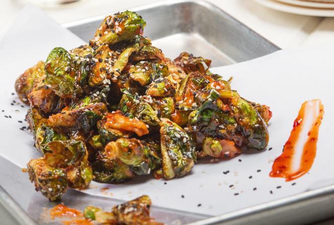 Crispy Brussel Sprouts · Pancetta nuggets, roasted sesame honey-chili glaze and puffed rice.