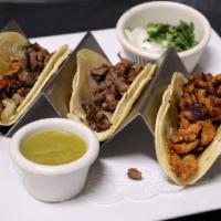 Street Tacos · 3 mini street tacos. Served with your choice of protein with cilantro, onions and tomatillo ...