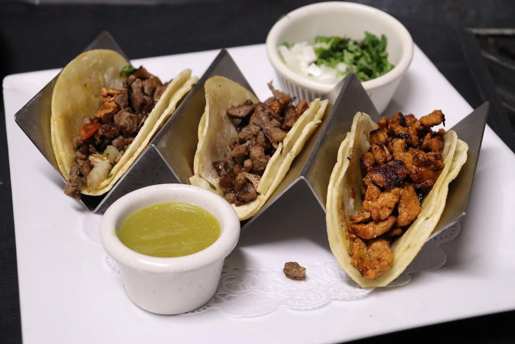 Street Tacos · 3 mini street tacos. Served with your choice of protein with cilantro, onions and tomatillo sauce.