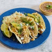 Tacos de Pierna · 3 tacos de carnitas with cilantro onion chicharron dust and avocado with a side of rice and ...