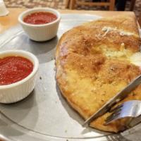 Plain Calzone · Half moon-shaped pizza dough, folded and filled with mozzarella and ricotta cheese