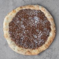 Nutella Pizza · Sweet pizza dough slathered with Nutella and powdered sugar.