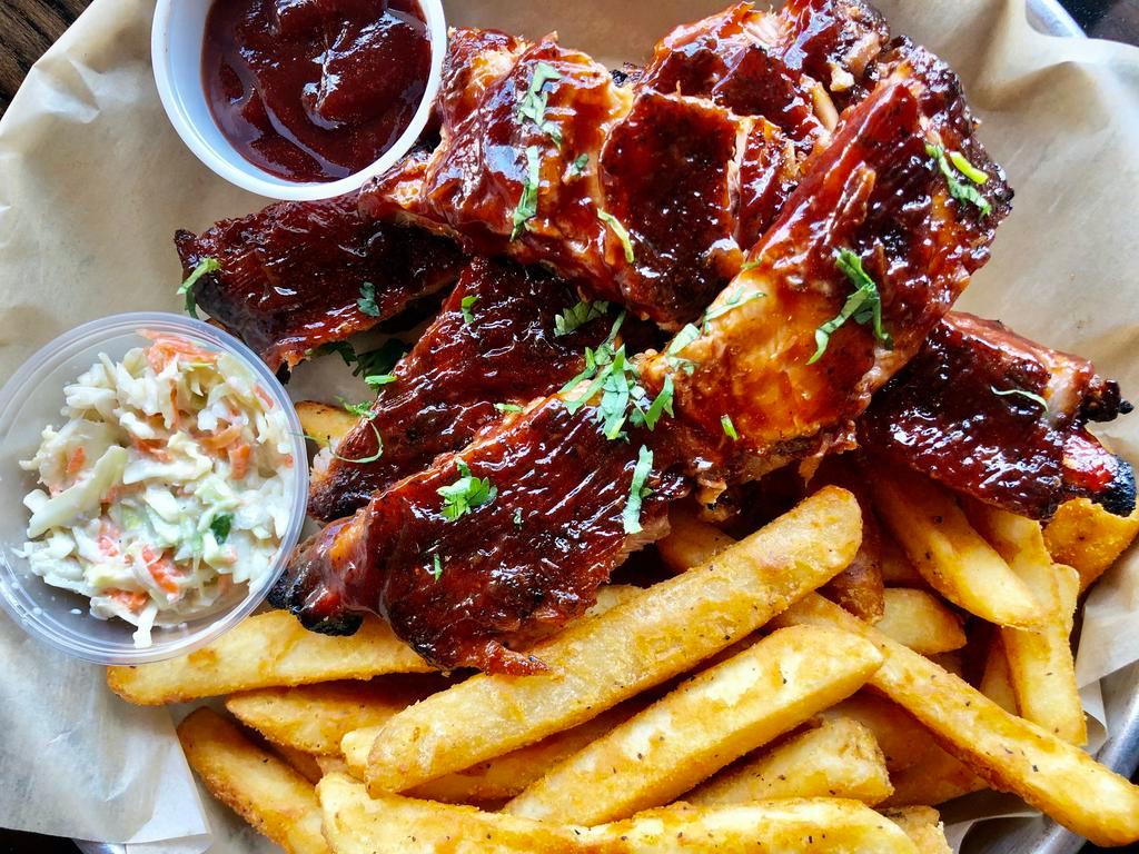Ribs con Papitas · Perfectly seasoned bbq ribs cooked in our charcoal over with a side of French fries and coleslaw 