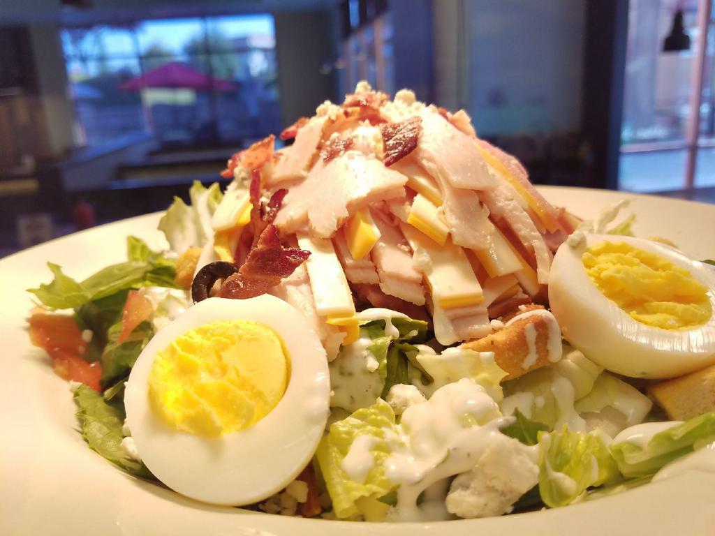 Chef Salad · Romaine, tomato, olives, onions, croutons, ham, turkey, American and Swiss cheese, boiled egg, dressing choice.