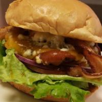 BlueBQ Moo Burger · On a kaiser bun, basted with zesty BBQ sauce, topped with bacon, cheddar and crumbled bleu c...
