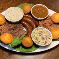 Family Meal 4-6 ppl · Combination of Pulled Pork, Brisket, choice of hot link or Bratwurst. Served with 2 choice o...