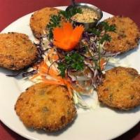 Corn Patties · 5 pieces. Deep-fried corn cakes, served with cucumber sauce with ground peanuts.