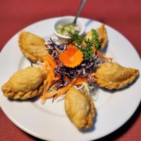 Karipap (Curry Puffs) · Five of our delicious handmade pastries rolled and filled with a delicious blend of yellow c...