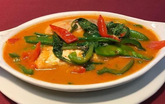 Salmon Curry  · Fillet of salmon cooked in red curry paste, coconut, bell pepper, snow peas, and basil leaves. Served with steamed rice.