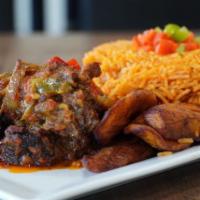 Jollof Rice and Stew Beef · Rice mixed with red tomato sauce and onions and grilled beef steak mixed with red tomato sau...