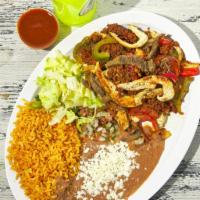 Fajita Texana · A mixture of steak, chicken, chorizo, and veggies served with rice and beans.