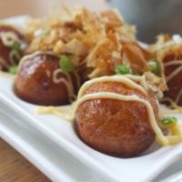 Takoyaki (6 pcs) · Fried octopus dumplings drizzled with Japanese mayonnaise, katsu sauce and sprinkled with bo...