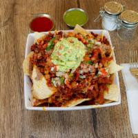 Nachos · Select choice of meat. Tortilla chips topped with Mexican cheese, beans, guacamole, & pico d...