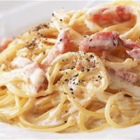 Spaghetti Carbonara · Spaghetti tossed with bacon, onion, egg yolk, cream, and black pepper.