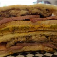 Cubano · carved turkey breast, ham, pulled pork, swiss, sweet pickles and cuban sauce on brioche