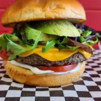 Impossible Burger (vegan) · 1/4 pound plant based impossible burger, red onion, tomato, greens and avocado with vegan ch...