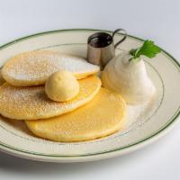 Classic Pancakes · A classic set of pancakes, topped with whipped cream and butter served with syrup.
