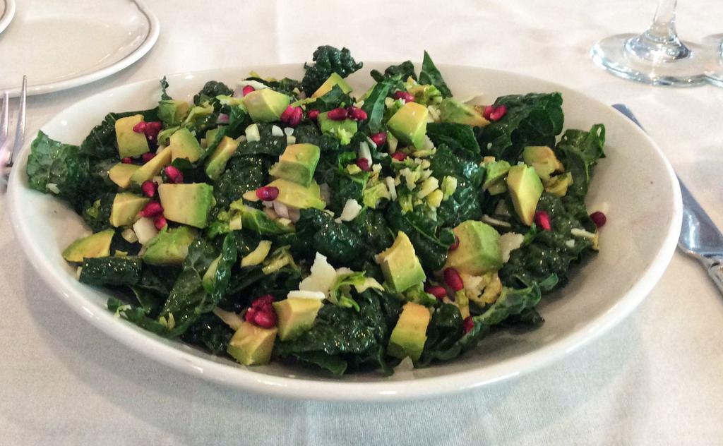 Kale & Brussel Sprout Salad · Diced Brussel sprouts, avocado, pomegranate seeds, shallots & shaved pecorino. Gluten free.