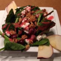 Spinach Salad · Baby spinach topped with goat cheese, walnuts, grapes, and apples dressed with a raspberry v...