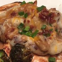 Loaded Chicken · Grilled chicken breast topped with garlic mashed potatoes, chicken gravy, scallions, Monterr...