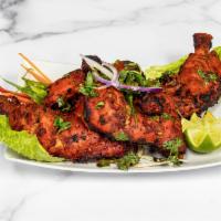 Tandoori Chicken (full) · Chicken leg quarter marinated in yogurt lemon juice and spl spices and cook in Clay oven 