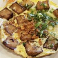 Pan Fried Rice Cake · Crispy rice cake with scrambled eggs, scallions, pickle carrots and daikon, served with soy ...