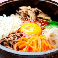 Dol Sot Bi-Bim-Bap · Our signature hot stone rice bowl served at 500 C, seasonal vegetables, overeasy egg, steame...