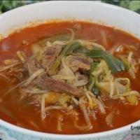 Yuk Gae Jang Soup · Spicy beef soup with vegetables and clear noodle.