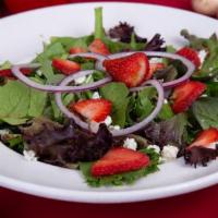 Strawberry Pecan Salad · Sliced strawberries, pecans and bleu cheese crumbles on a bed of spring mix and topped with ...
