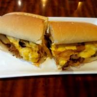 Classic Philly Cheese Steak · 1/2 lb. of thinly sliced Black Angus rib-eye steak with sauteed onions and melted American c...