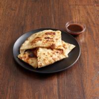 Plain Naan · White flour bread baked in the tandoor
with or without a touch of butter