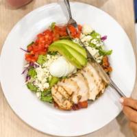 American Garden Cobb Salad · Chopped greens, pasture raised hard boiled eggs, organic grilled chicken, crisp bacon, tomat...