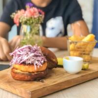Salmon Burger · Wild caught salmon patty, cabbage, capers cream, chipotle aioli and served with crispy yuca ...