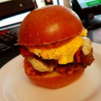Breakfast Burger · Hash brown topped with cheddar cheese, bacon, and fried egg on the top. Served on a brioche ...