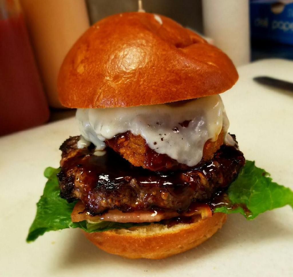 Texas Style Burger · Onion rings, provolone, and BBQ sauce. Served on a brioche bun.
