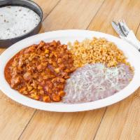 Puerco En Chile Colorado · Chunks of pork cooked in a tasty red sauce served with a side of rice and beans and corn or ...