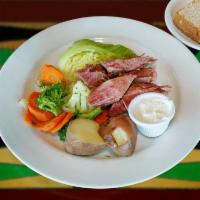Corned Beef and Cabbage Dinner · Slow roasted and served with roasted red potatoes, cabbage, seasonal vegetables and horserad...