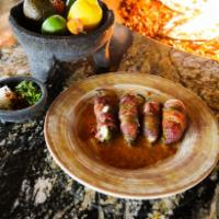 Stuffed Jalapenos · 4 fresh grilled jalapenos stuffed with spiced Philly cream cheese and wrapped with applewood...