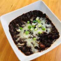 Chipotle Black Beans · Black beans simmered w/ peppers, onions, tomatoes, SW spices & herbs topped w/ Cotija cheese