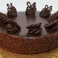 Chocolate Truffle Cake · Flourless Belgian chocolate torte, chocolate ganache glaze.  Served w/ whipped cream & brand...